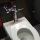 A girl sets up a camera in a public restroom stall and records herself pissing and taking a wet, explosive-sounding shit. Over 5.5 minutes.